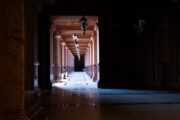 Dark uncanny corridor illustrating Jeffrey Thomas's LORE review of The Orphan Palace