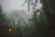 House surrounded by fog and trees evoking Cosmic Gothic atmosphere