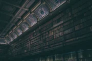 Dark historic library evoking forbidden knowledge and eldritch horror